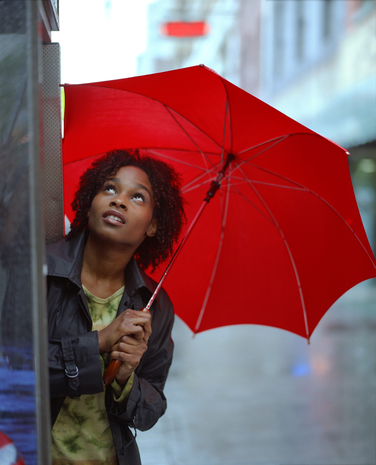 Woman in rain with red umbrella